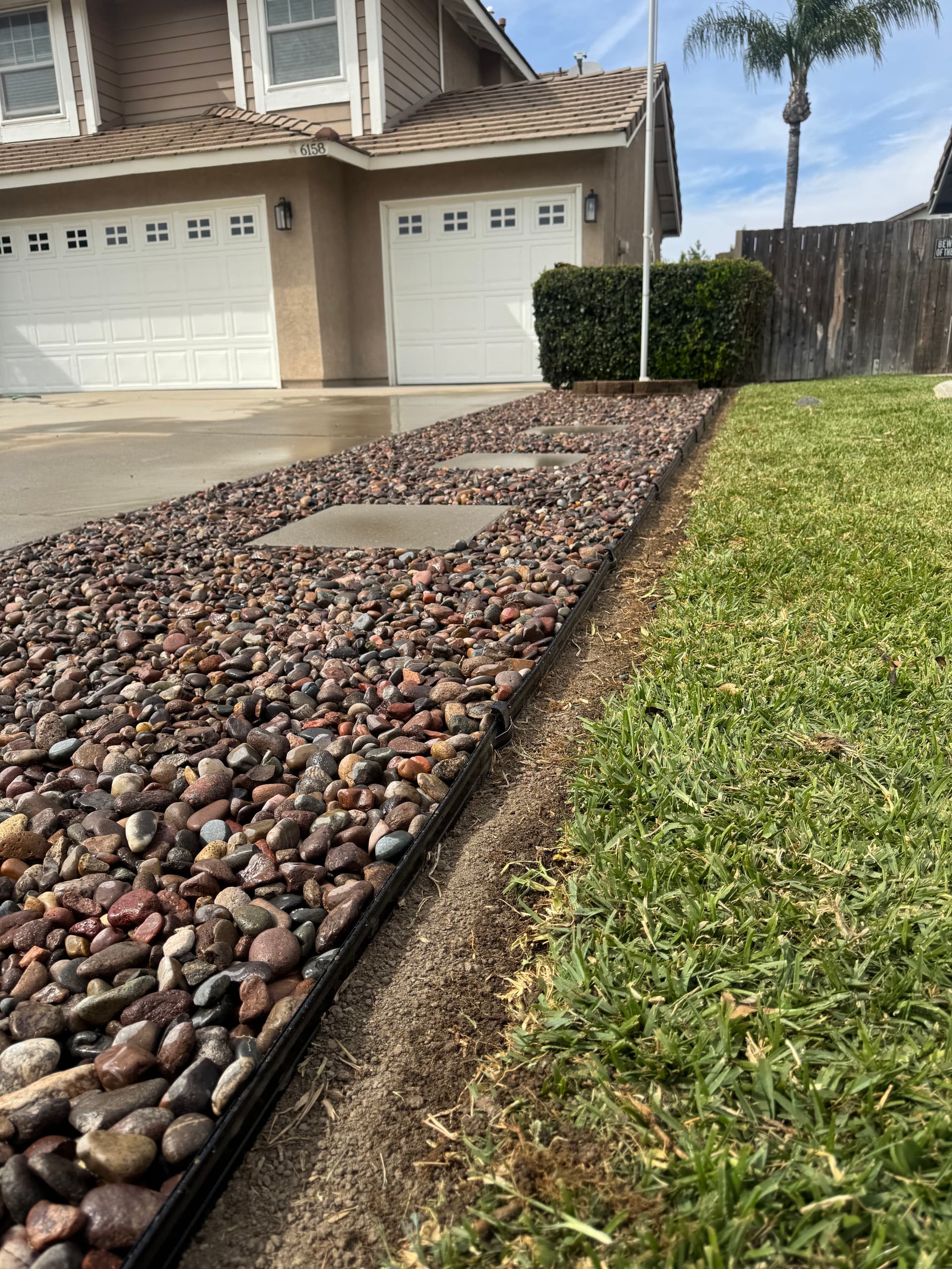 Less Lawn, More Curb Appeal With River Rock and Clean Edging image
