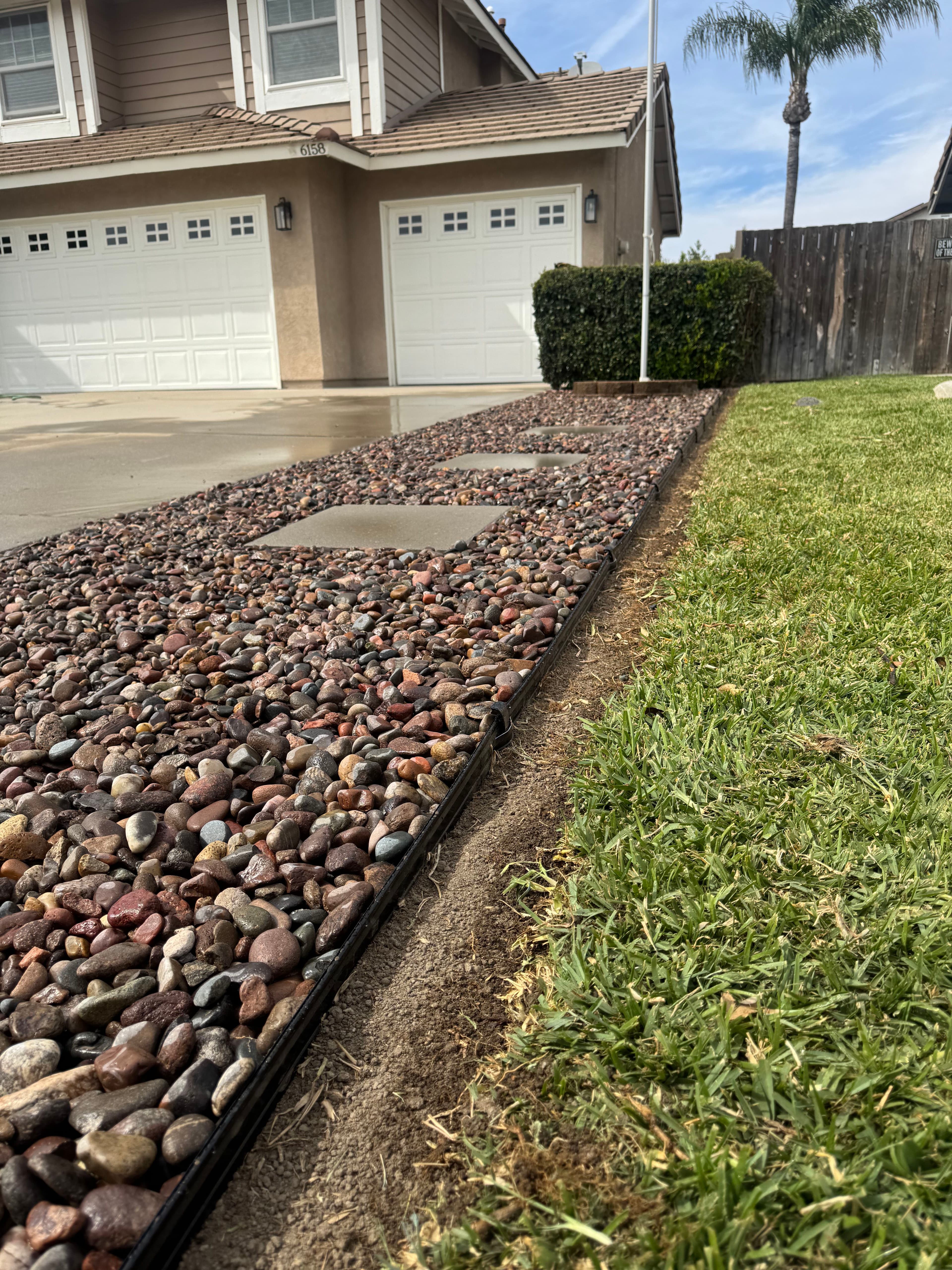 Project Less Lawn, More Curb Appeal With River Rock and Clean Edging image